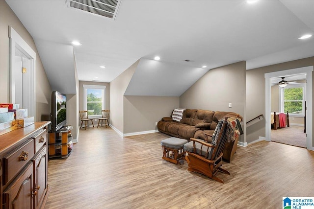 living room featuring visible vents, plenty of natural light, and light wood-type flooring