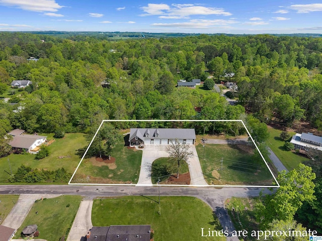 birds eye view of property with a forest view