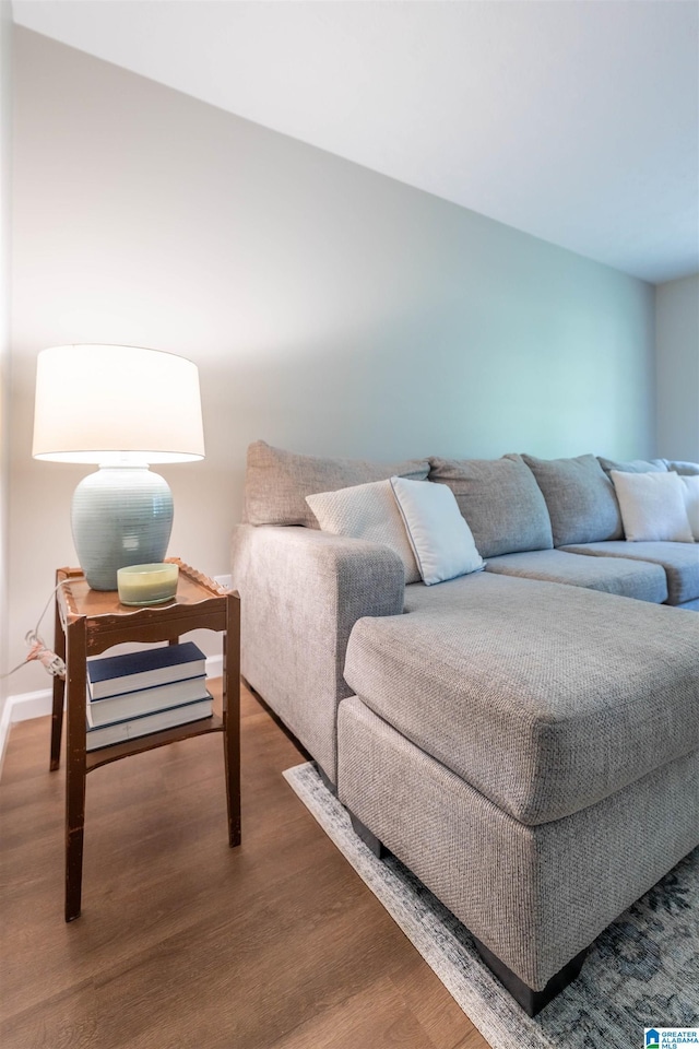 interior space featuring baseboards and wood finished floors