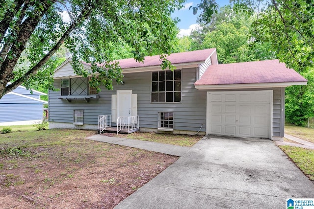 split foyer home with a garage and concrete driveway