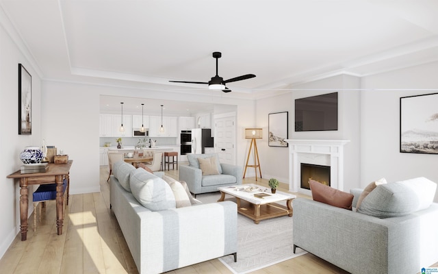 living room featuring baseboards, a ceiling fan, light wood-style flooring, and a lit fireplace