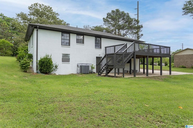 733 Heflin Ave E, Birmingham, AL 35214 - rear view of house with a lawn, a wooden deck, stairway, brick siding, and central AC