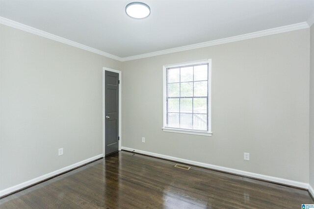 733 Heflin Ave E, Birmingham, AL 35214 - spare room featuring visible vents, ornamental molding, baseboards, and wood finished floors
