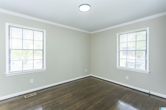 733 Heflin Ave E, Birmingham, AL 35214 - spare room with baseboards, ornamental molding, dark wood-style flooring, and visible vents