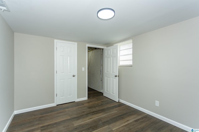 733 Heflin Ave E, Birmingham, AL 35214 - unfurnished bedroom featuring dark wood-style flooring and baseboards