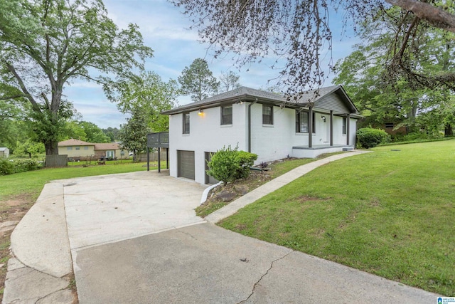 733 Heflin Ave E, Birmingham, AL 35214 - view of front facade featuring a garage, concrete driveway, a front lawn, and brick siding