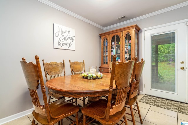 dining room with baseboards, visible vents, ornamental molding, and light tile patterned floors