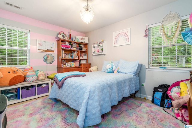 bedroom featuring visible vents, baseboards, and a notable chandelier