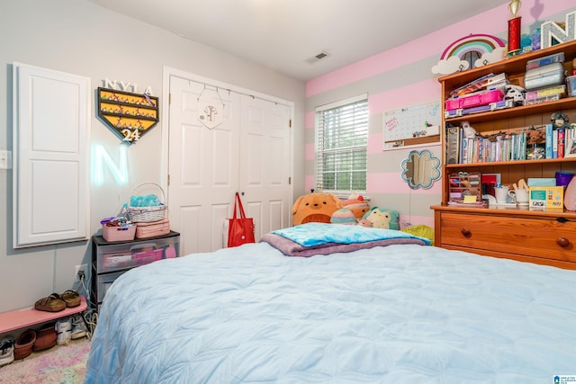 bedroom featuring visible vents and a closet