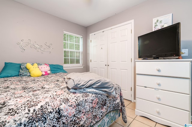 bedroom with a closet and light tile patterned floors