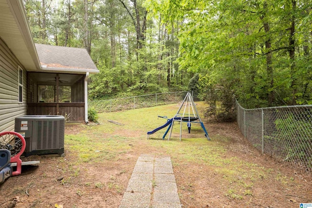 view of yard featuring fence, central AC unit, and a sunroom