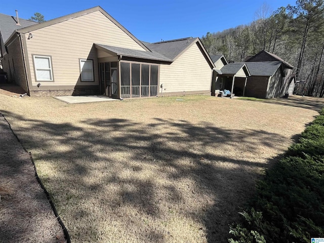 1516 James Hill Way, Hoover, AL 35226 - rear view of property featuring a yard, a patio area, and a sunroom