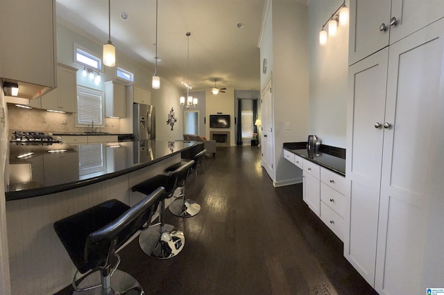 1516 James Hill Way, Hoover, AL 35226 - kitchen featuring a sink, appliances with stainless steel finishes, dark countertops, and a breakfast bar