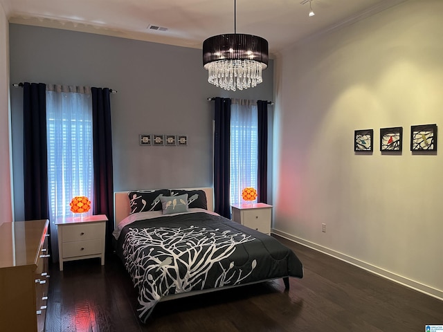 1516 James Hill Way, Hoover, AL 35226 - bedroom featuring visible vents, crown molding, wood finished floors, baseboards, and an inviting chandelier