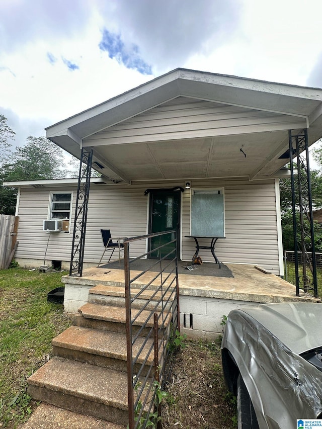view of front of house featuring a porch and cooling unit