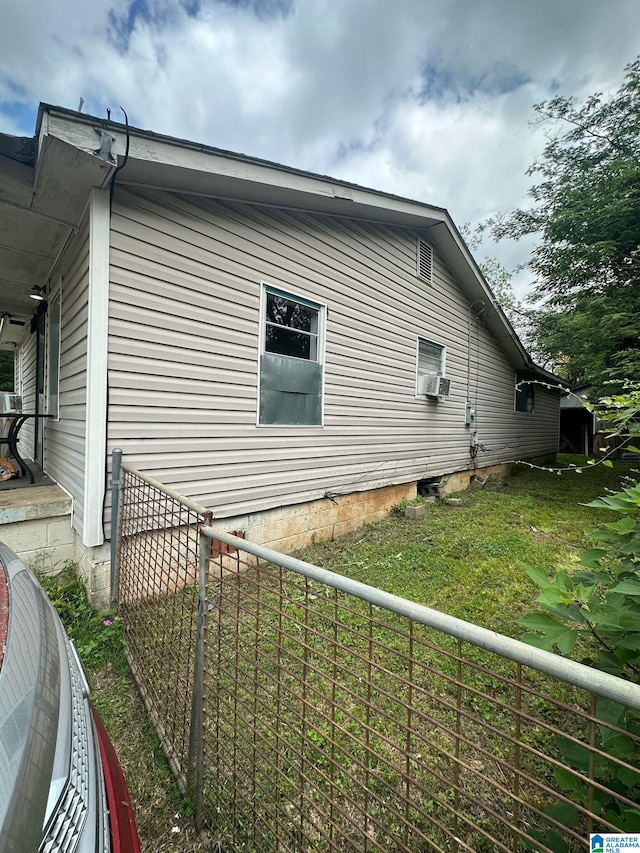 view of property exterior with a lawn