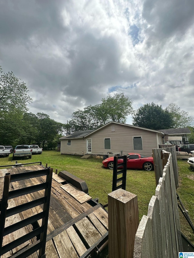 wooden deck with a lawn