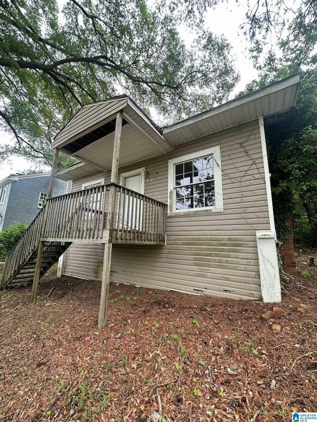 exterior space featuring stairway and a wooden deck