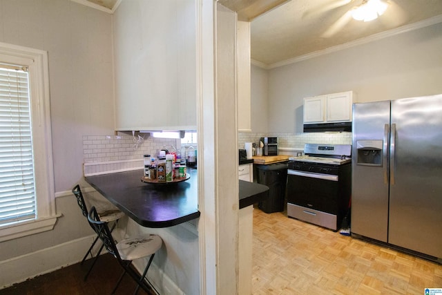 402 8th St, Clanton, AL 35045 - kitchen with stainless steel fridge, range with gas stovetop, crown molding, under cabinet range hood, and backsplash