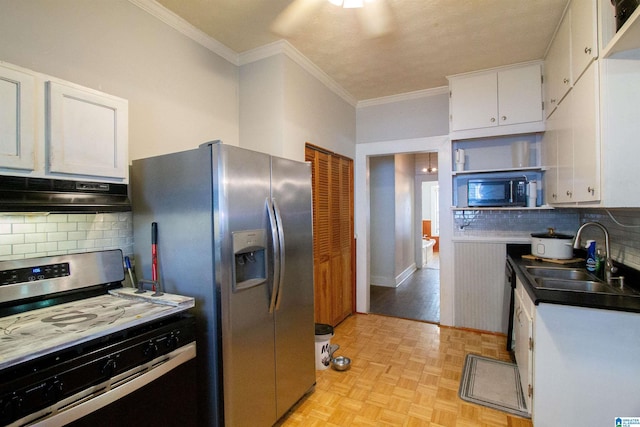 402 8th St, Clanton, AL 35045 - kitchen with appliances with stainless steel finishes, a sink, under cabinet range hood, white cabinets, and tasteful backsplash