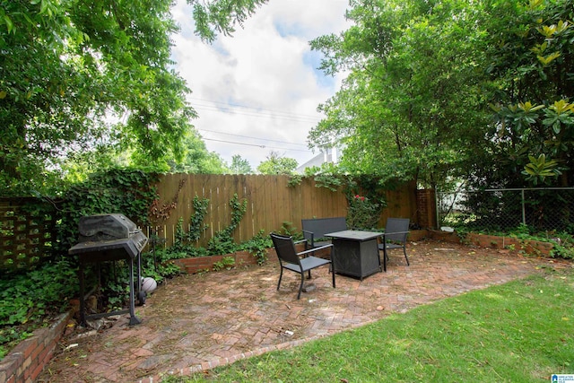 402 8th St, Clanton, AL 35045 - view of patio featuring an outdoor fire pit, a fenced backyard, and grilling area