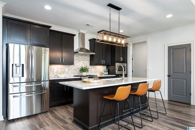 3304 Trip Run, Hoover, AL 35244 - kitchen featuring stainless steel refrigerator with ice dispenser, wall chimney exhaust hood, a sink, crown molding, and a center island with sink