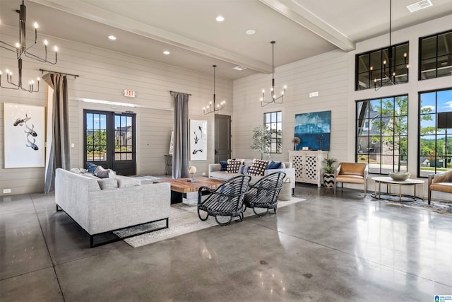 3304 Trip Run, Hoover, AL 35244 - living area featuring a chandelier, concrete flooring, beamed ceiling, a high ceiling, and wood walls