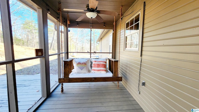 sunroom with plenty of natural light and a ceiling fan