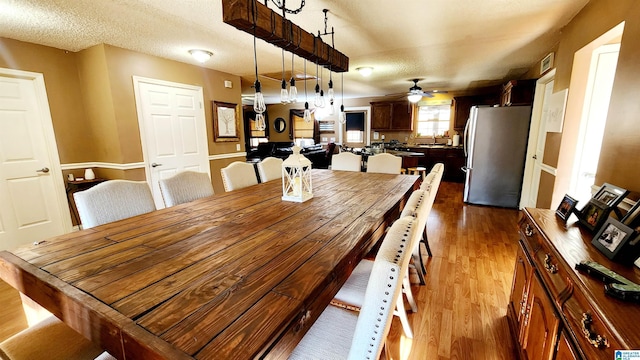 dining space featuring ceiling fan and wood finished floors