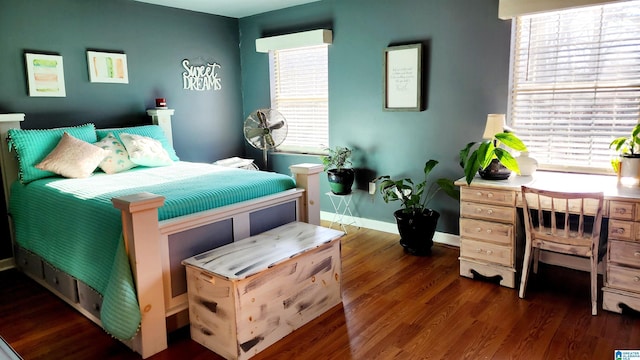 bedroom with baseboards and wood finished floors