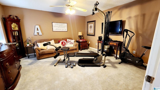 exercise area featuring carpet floors, ceiling fan, and baseboards