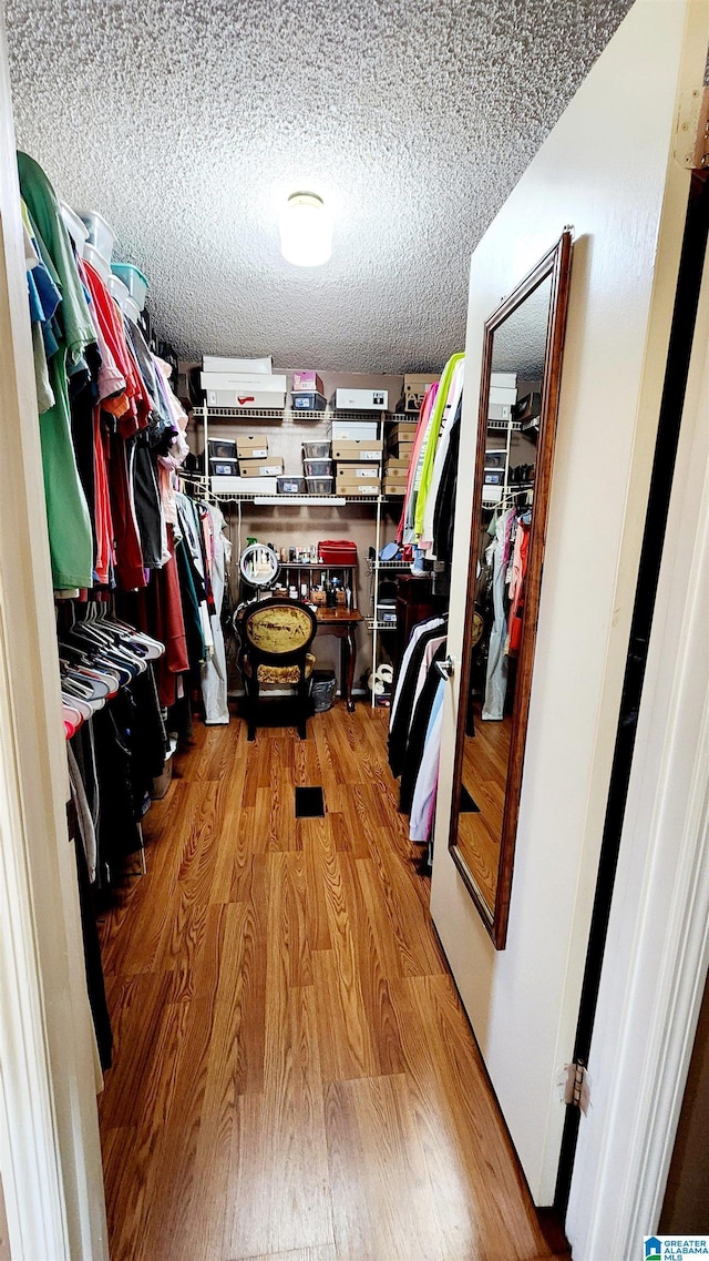 walk in closet featuring wood finished floors
