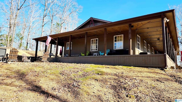 back of property with covered porch