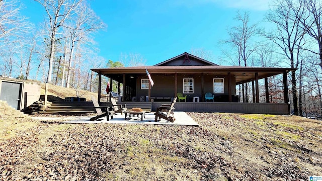 back of property featuring a fire pit