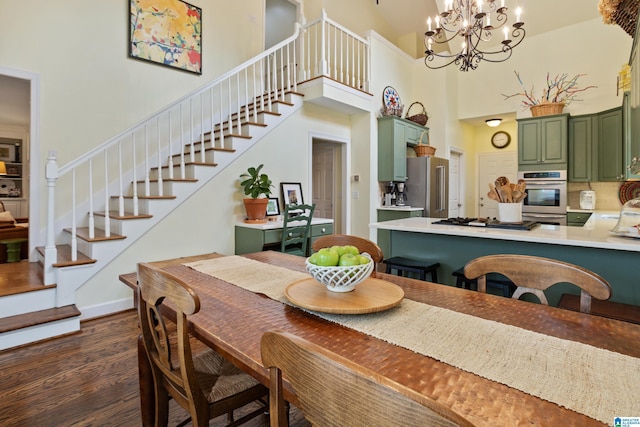 dining space featuring dark wood-style flooring, a high ceiling, a chandelier, and stairway