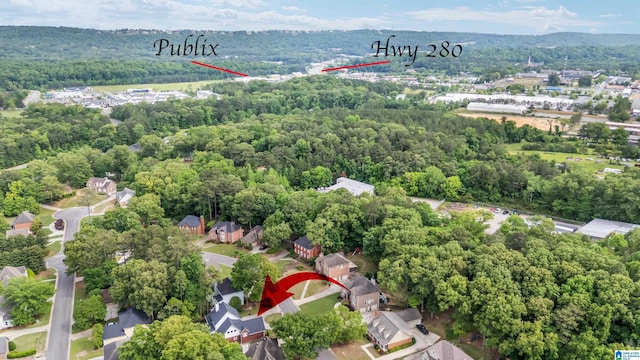 birds eye view of property featuring a wooded view