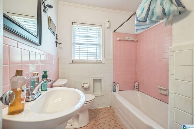 bathroom with a sink, toilet, shower / washtub combination, tile walls, and ornamental molding