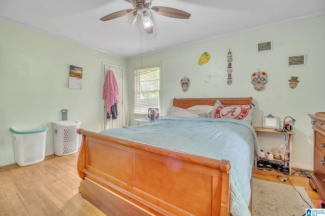 bedroom featuring crown molding, baseboards, ceiling fan, and light wood-style flooring