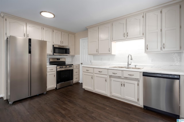 5708 Hickory Ct, Pinson, AL 35126 - kitchen featuring appliances with stainless steel finishes, a sink, backsplash, and dark wood-type flooring