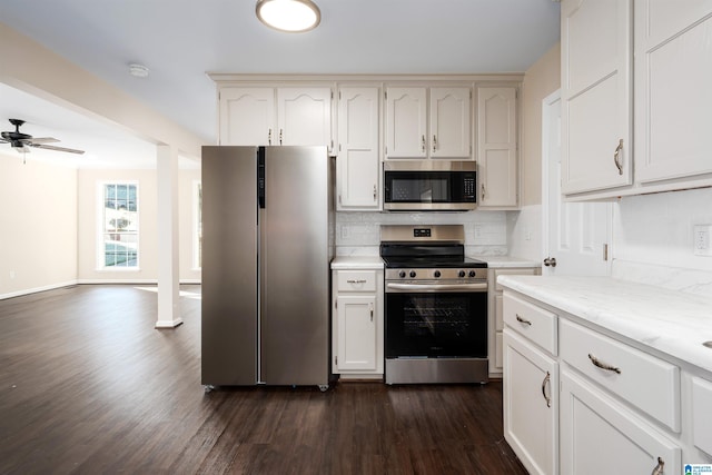 5708 Hickory Ct, Pinson, AL 35126 - kitchen with stainless steel appliances, dark wood-style floors, decorative backsplash, a ceiling fan, and white cabinets