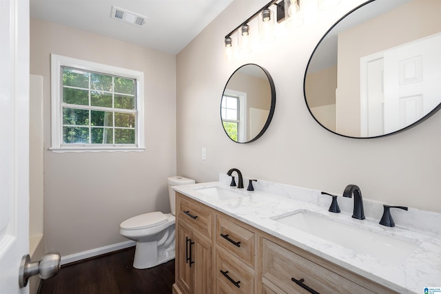 5708 Hickory Ct, Pinson, AL 35126 - bathroom featuring toilet, wood finished floors, baseboards, and double vanity