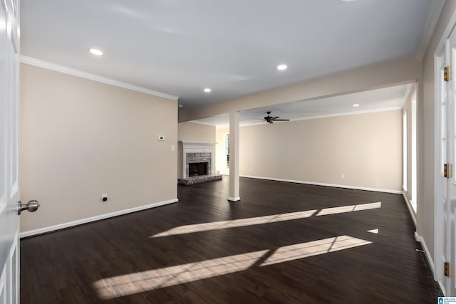 5708 Hickory Ct, Pinson, AL 35126 - unfurnished living room featuring ornamental molding, dark wood-style flooring, baseboards, ceiling fan, and a stone fireplace