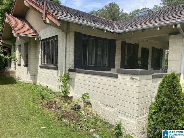 view of side of home with a yard