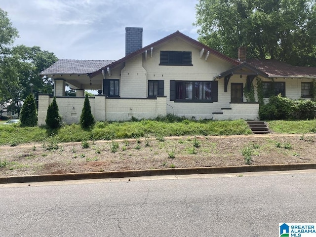 bungalow featuring a chimney