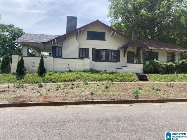 bungalow-style home with a chimney
