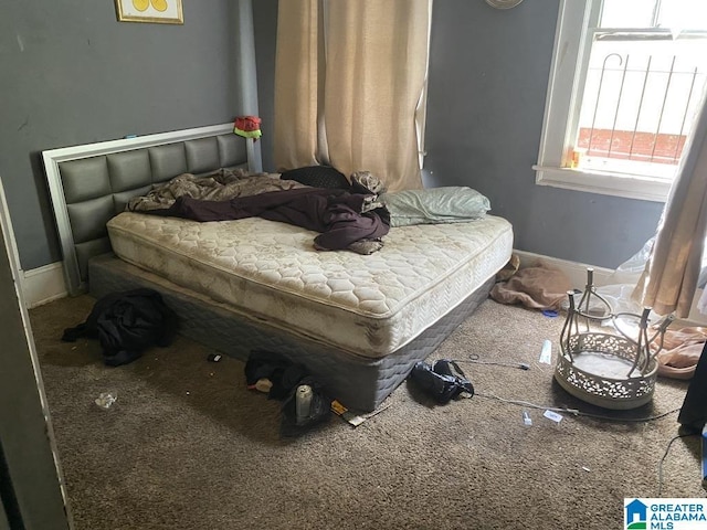 carpeted bedroom featuring baseboards