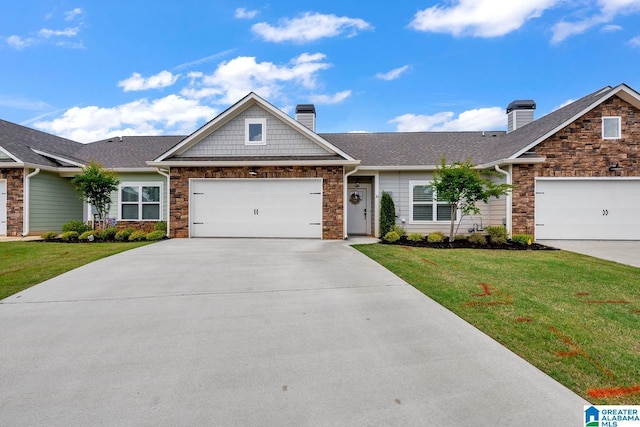 view of front of house with concrete driveway, a chimney, stone siding, and a front lawn