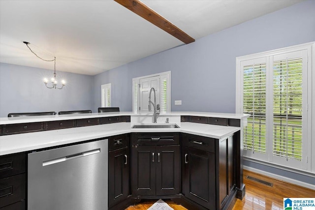kitchen with visible vents, light wood-type flooring, light countertops, a sink, and dishwasher
