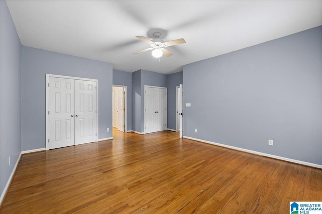 unfurnished bedroom with baseboards and wood finished floors
