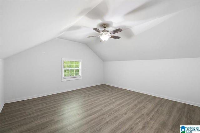 bonus room with ceiling fan, baseboards, vaulted ceiling, and wood finished floors